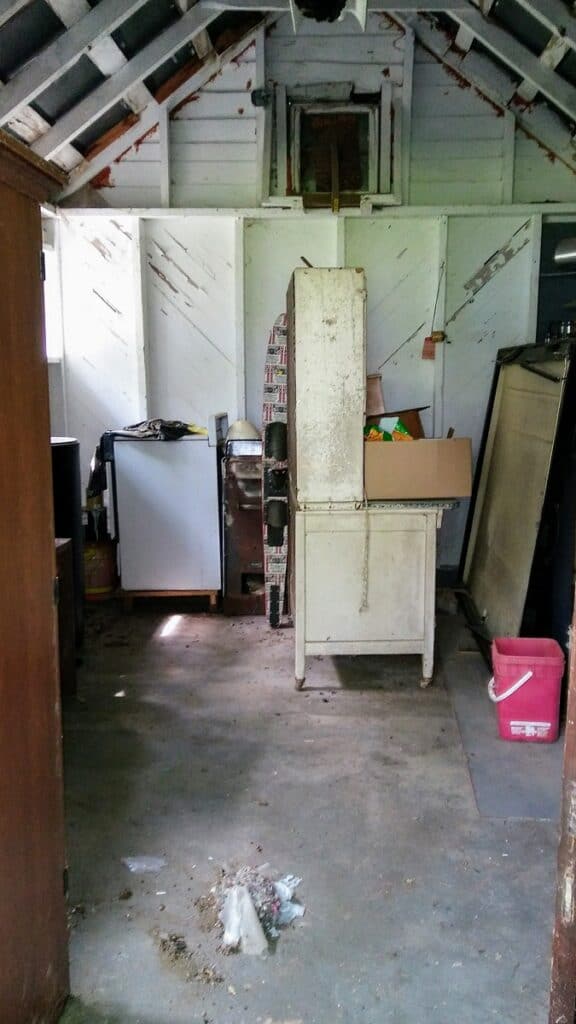 interior of old shed with tin roof and wood slat walls