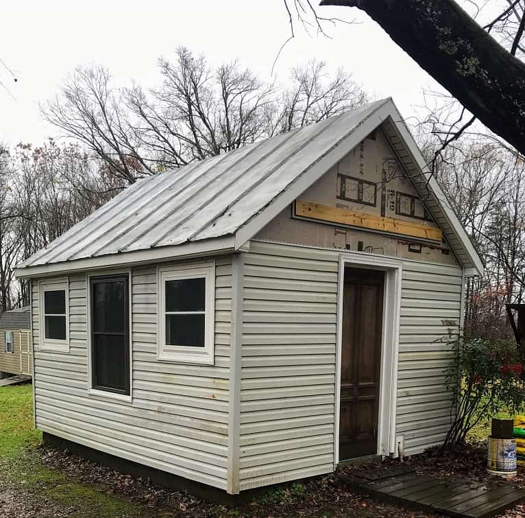 she shed with vinyl siding partially installed