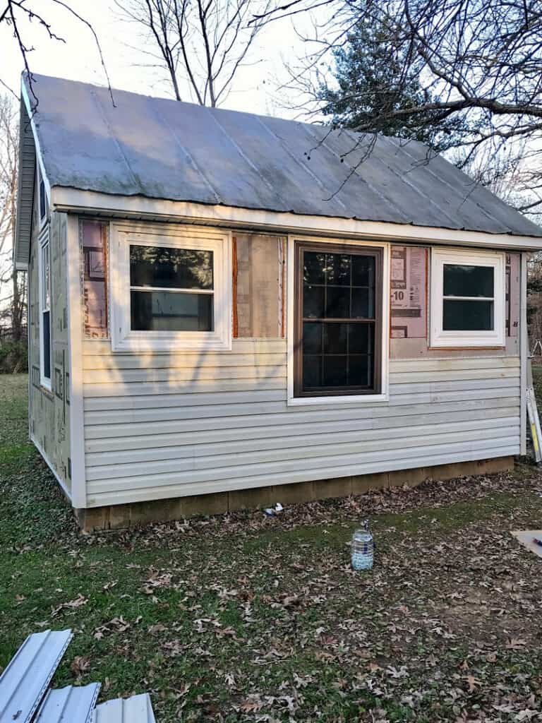 she shed with vinyl siding partially installed