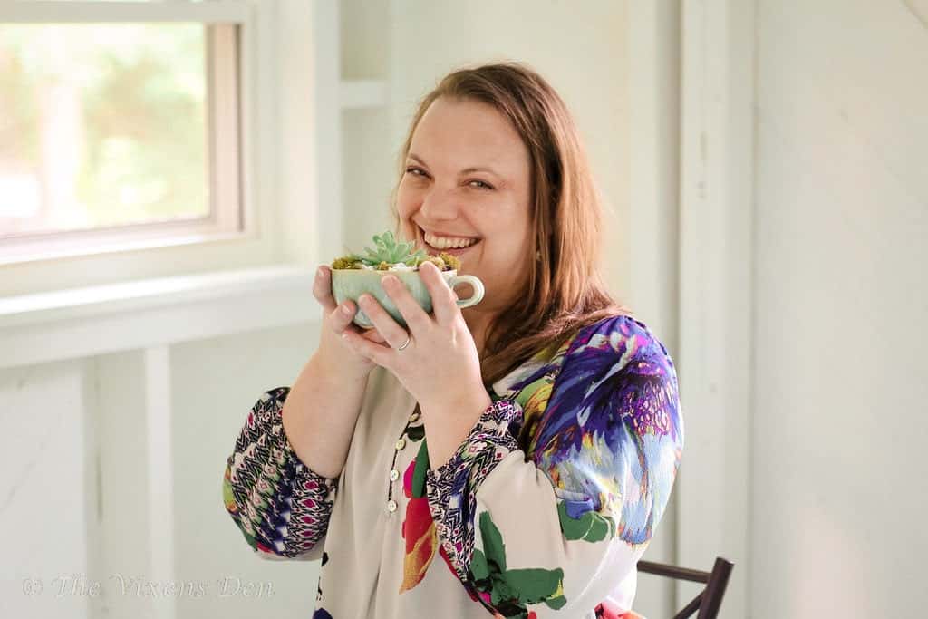 Becky holding aqua teacup with succulent