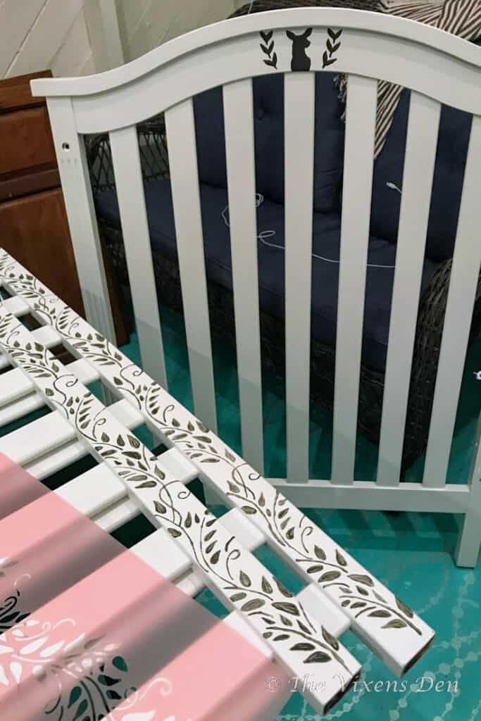 painted and stenciled crib with deer head and vine stencils