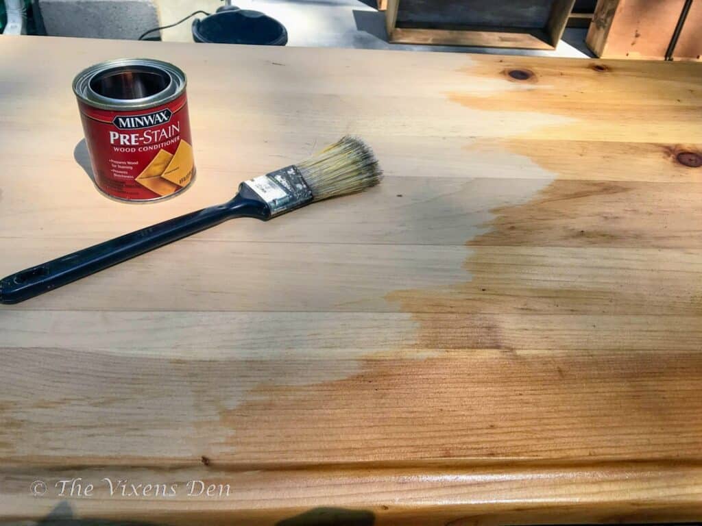 dresser top with wood conditioner partially applied