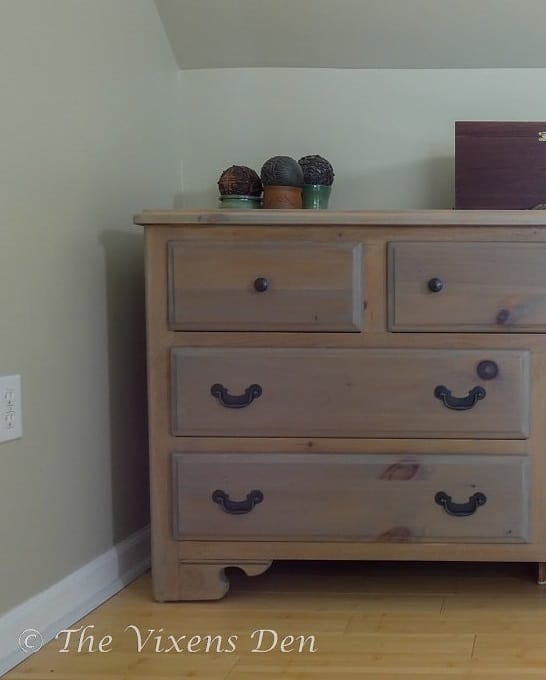 natural wood stained dresser with black matte hardware