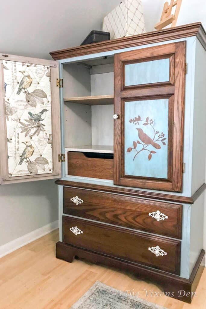 paint washed and stained armoire with fabric covered cork board