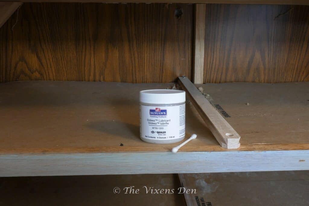 drawer slide with container of Slideez drawer lubricant and a cotton swab