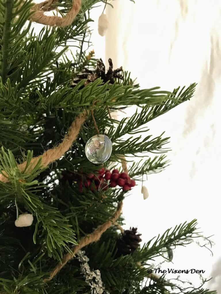 close up of mini Christmas tree decorated with DIY ornaments