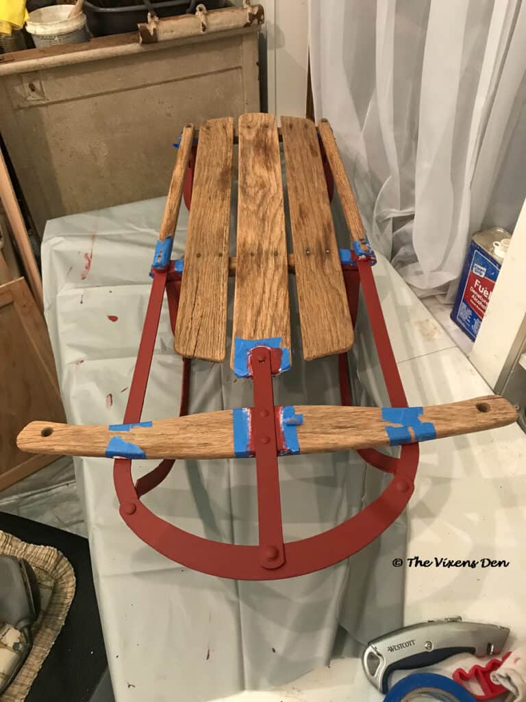 vintage sled runners painted and touched up with rustic red chalk paint
