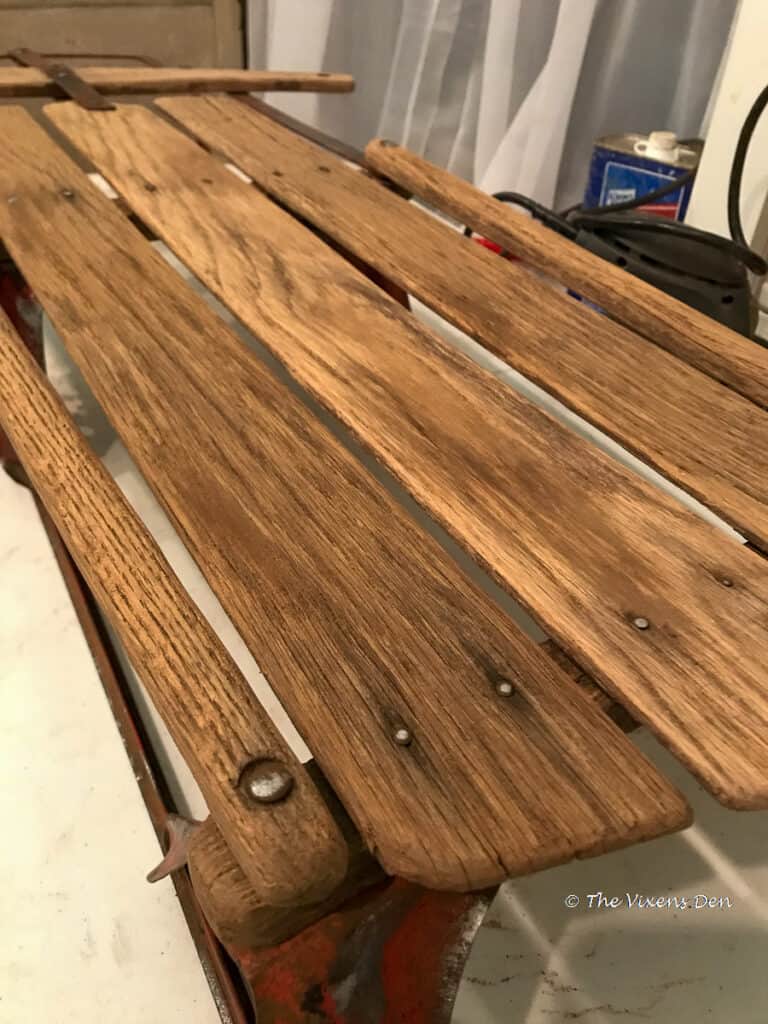 closeup of vintage sled bed after being wire brushed, sanded, and vacuumed