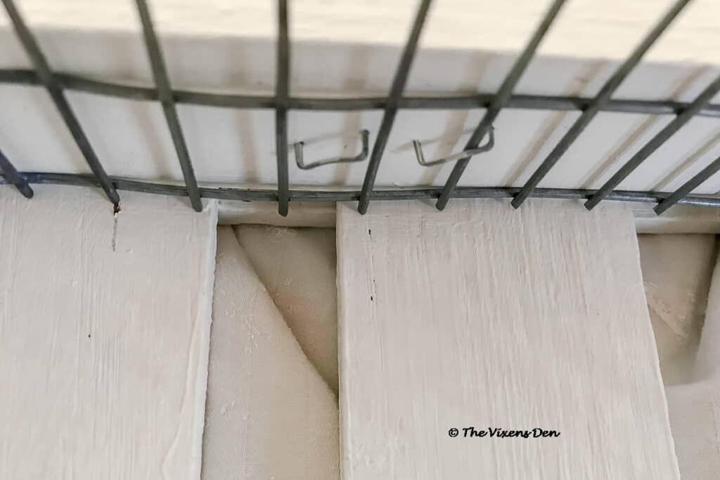 staples holding hardware cloth to the inside of the magazine rack