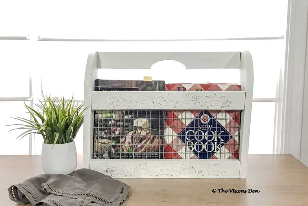 repurposed magazine rack staged as a cookbook caddy