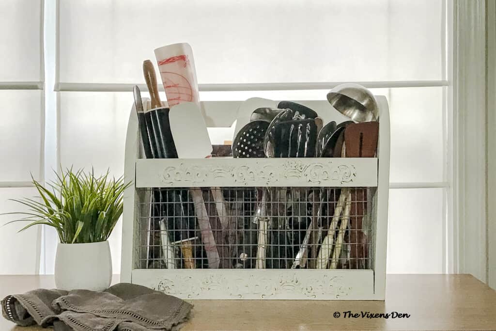repurposed magazine rack staged with kitchen utensils