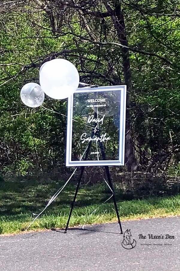 DIY glass chalkboard sign on an easel with balloons