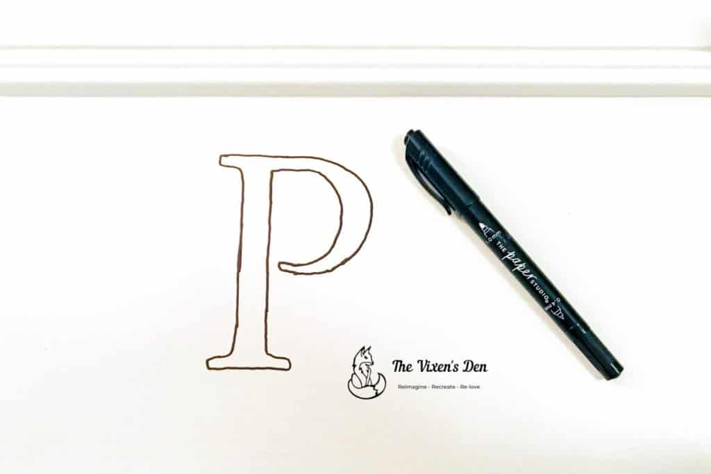 letter p traced on cabinet door with permanent pen