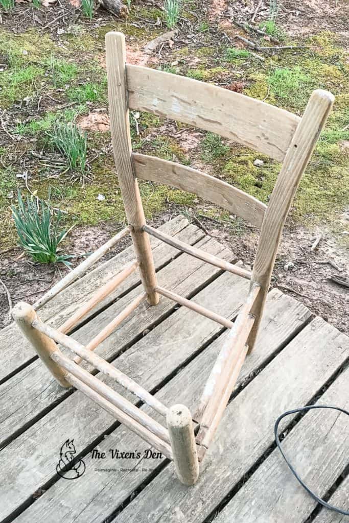 ladderback chair with missing nails and holes in the supports