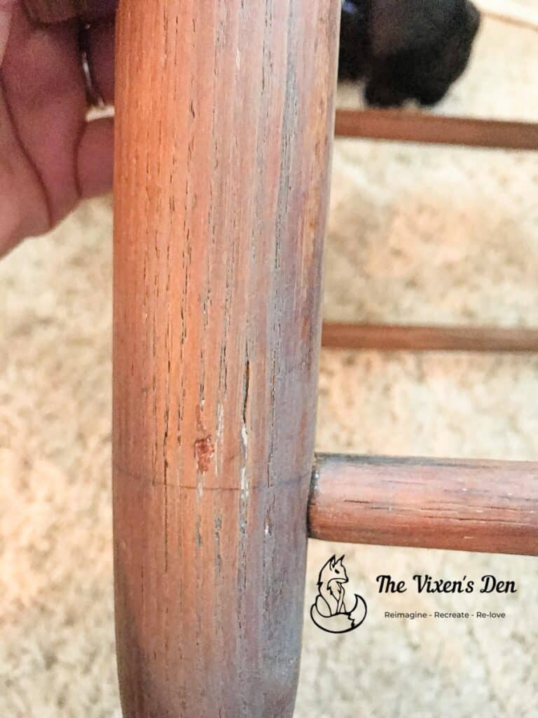 ladderback chair leg with wood filler that has been colored with a touchup marker