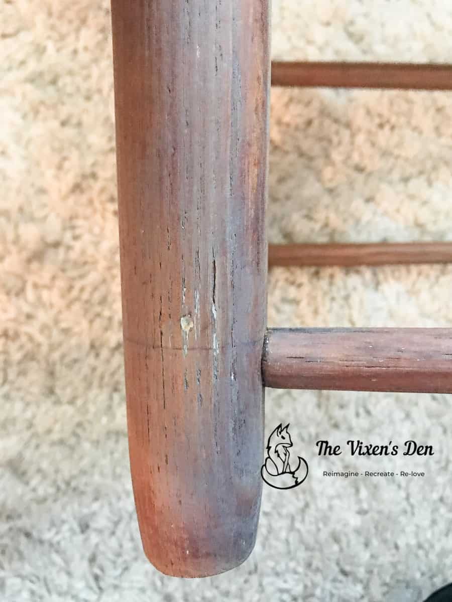 ladderback chair leg with wood filler before being colored with a touchup marker