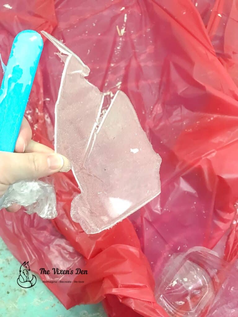 peeling dried resin off of a silicone stir and plastic drop cloth