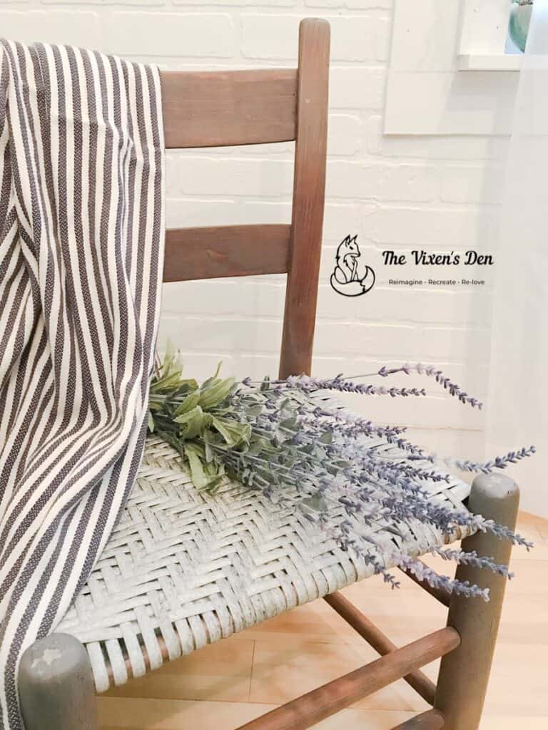 ladderback chair with woven seat, lavendar and a striped blanket-1-min
