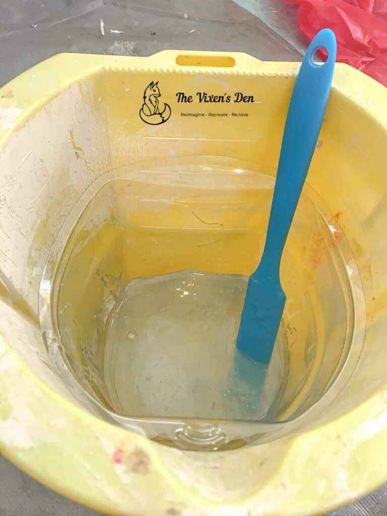 mixing the two epoxy resin parts in a paint bucket with a paint pail liner and a silicone stir spatula-1-min