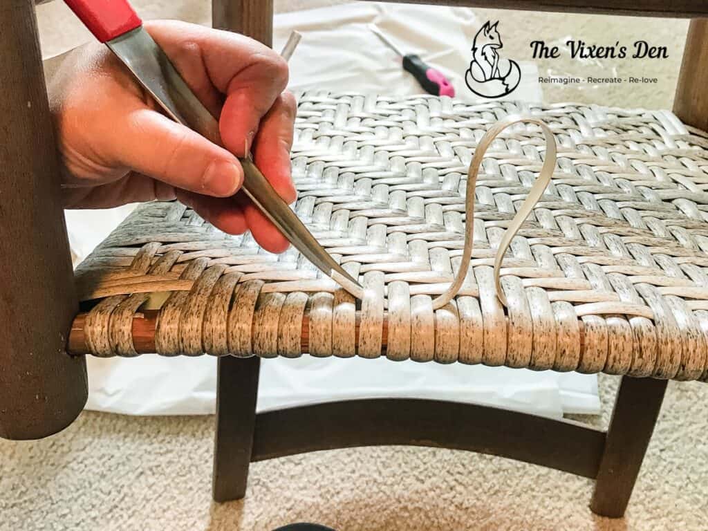 using a tool to weave in the tail of a faux rattan flat reed strand-1-min