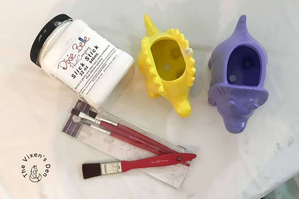 ceramic dinosaurs with slick stick and paintbrushes