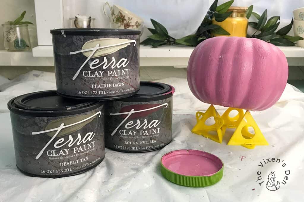 Breast Cancer Pink Pumpkin on Paint Pyramids with stacked cans of Terra Clay Paint