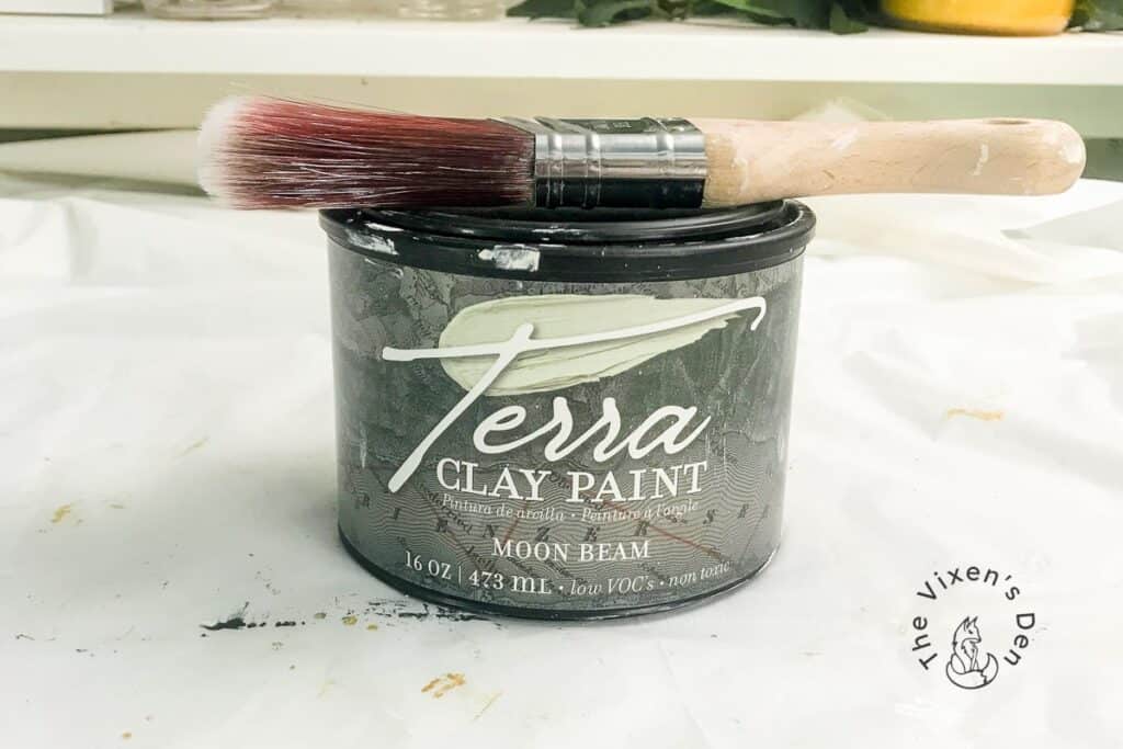 Jar of Terra Seal with a paintbrush on top