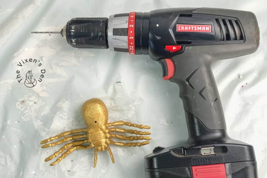 process - drill with gold painted spider