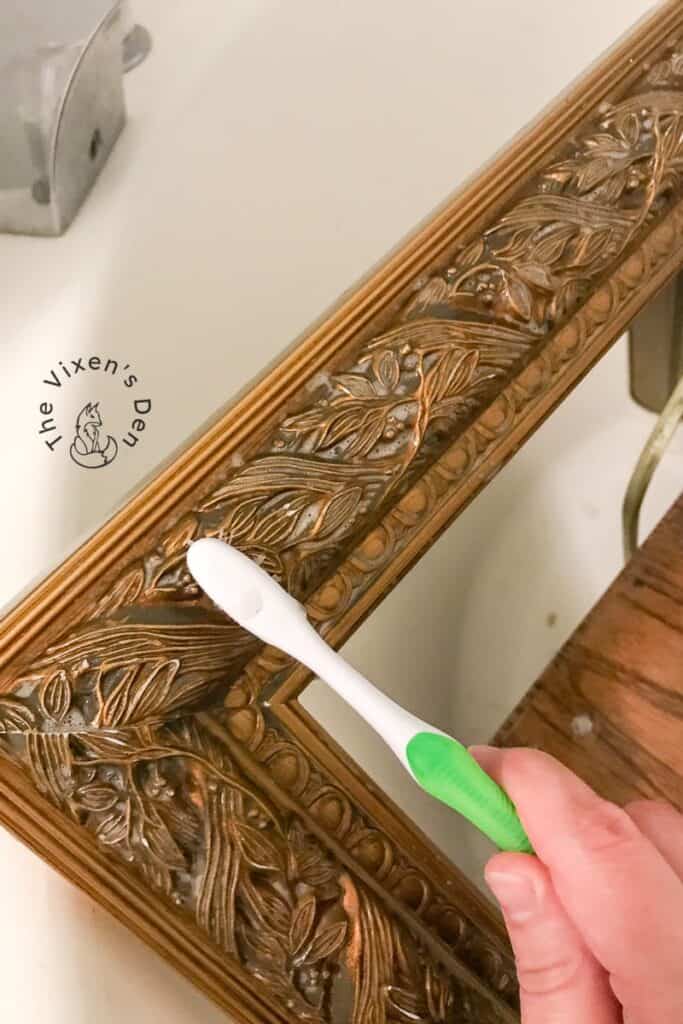 process - scrubbing picture frame with toothbrush