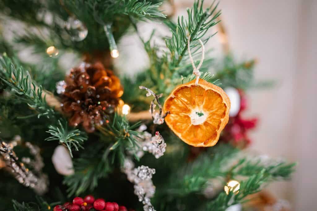 closeup of tabletop Christmas tree with dried clementine orange slice ornament