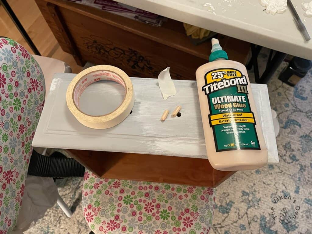 Drawer front with a roll of tape and a bottle of Titebond wood glue