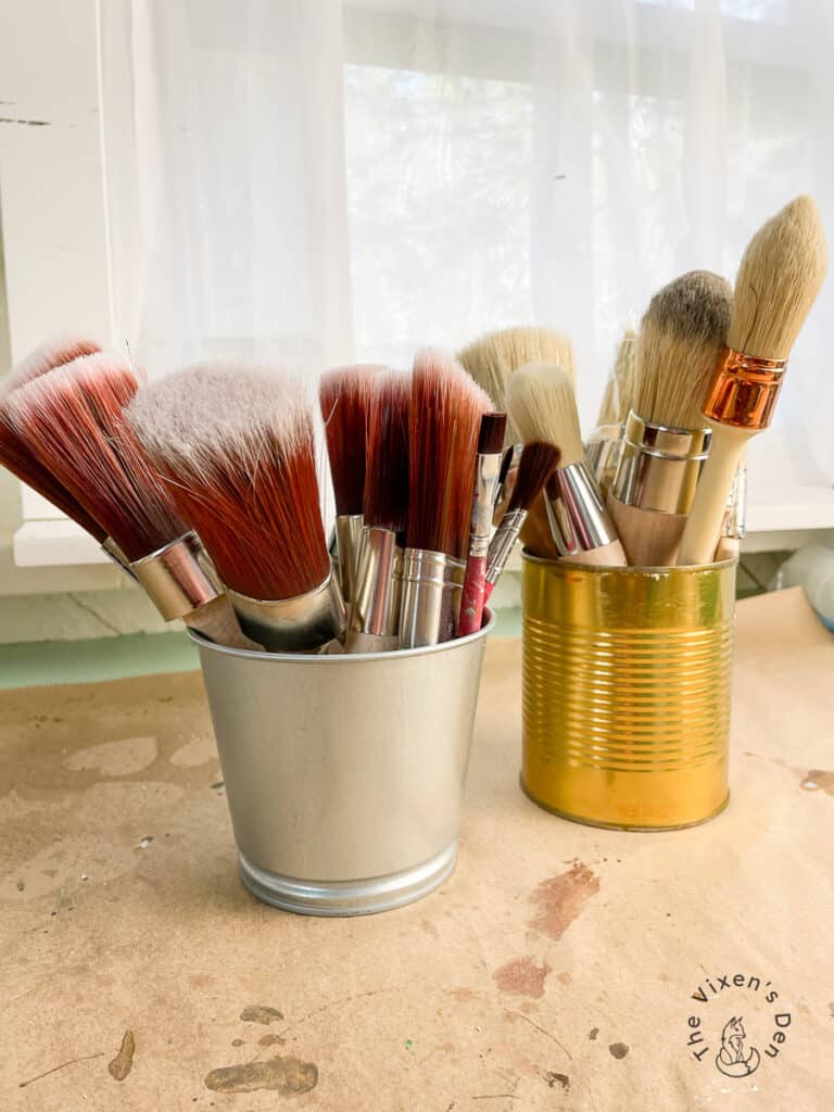 Paintbrushes Stored in Tins