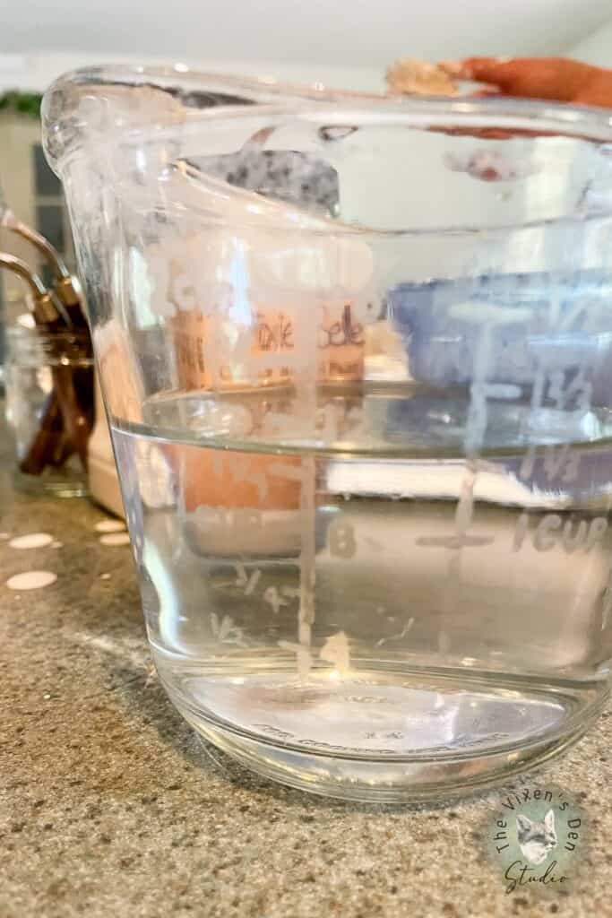 Water and Sola Softener in glass measuring cup