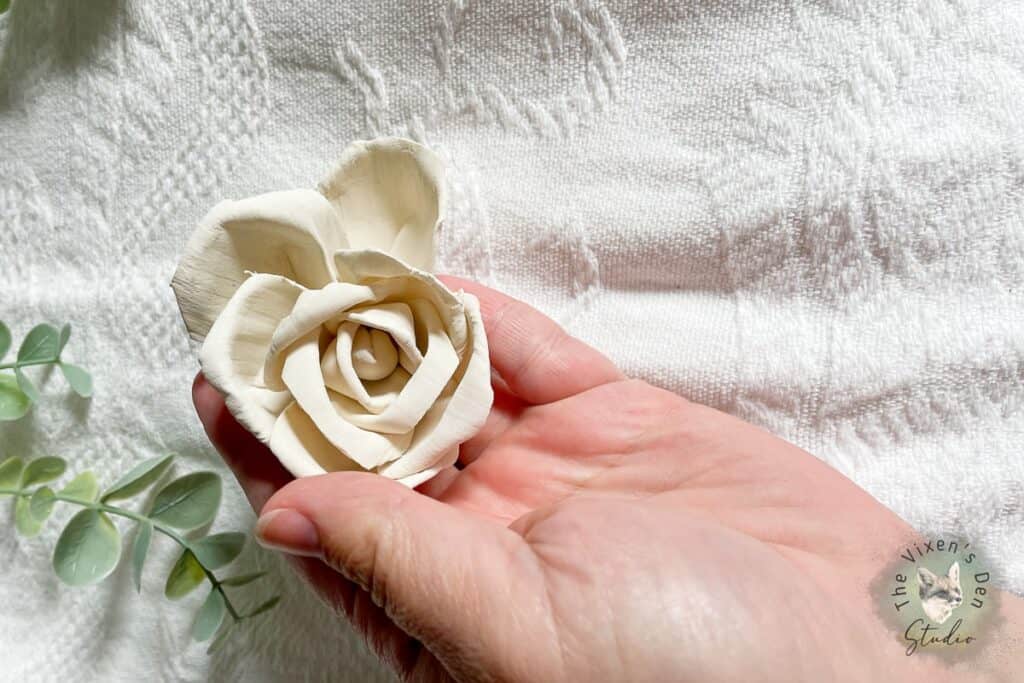 A Dyed Sola Wood Flower in a hand