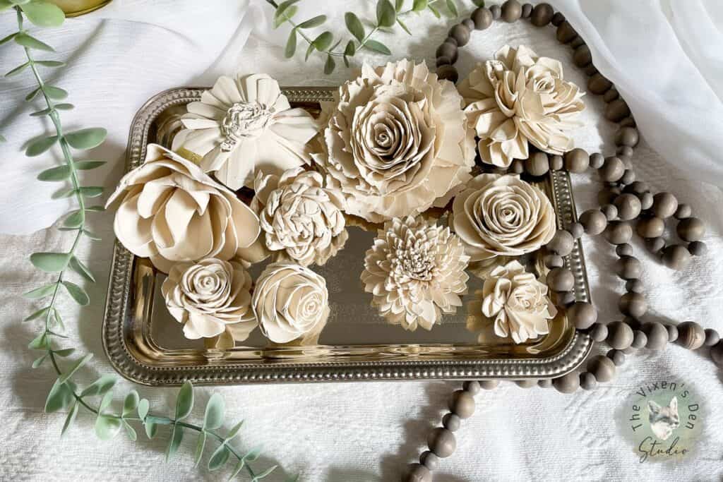 Dyed Sola Wood Flowers Single Color Dye staged on a silver tray with wood beads.1