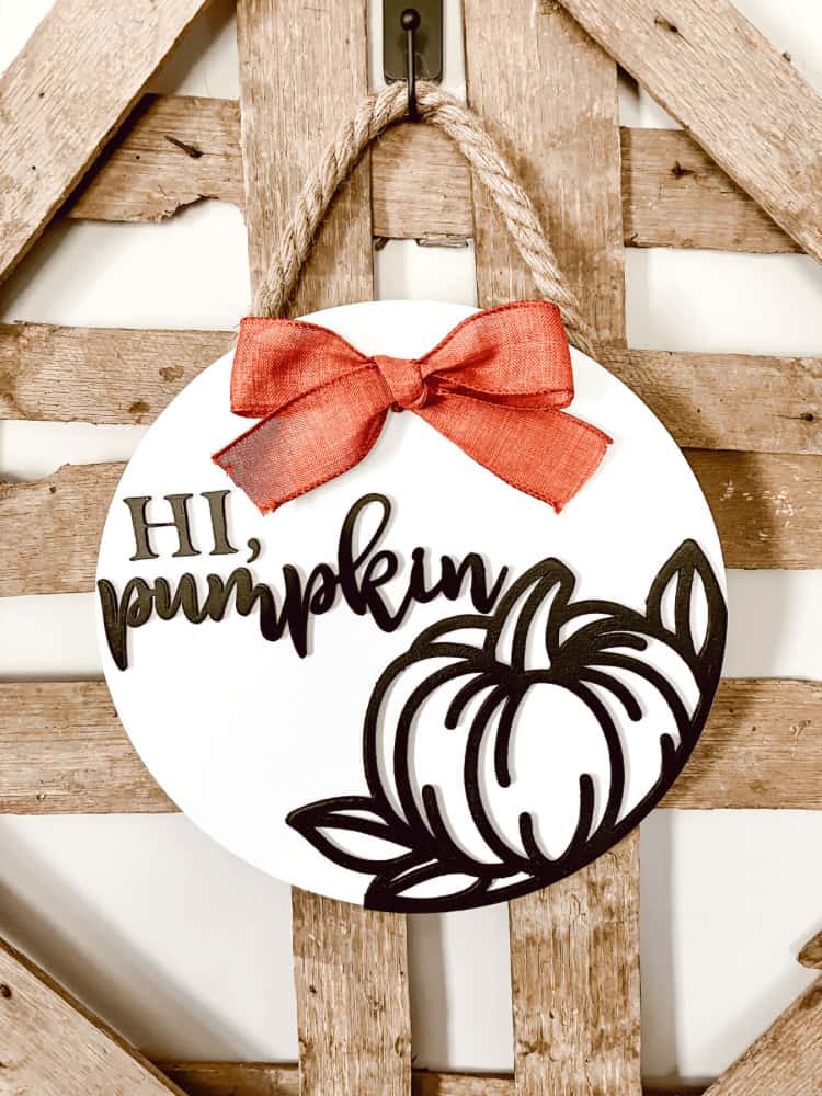 A wooden sign with the words hi pumpkin hanging on it.