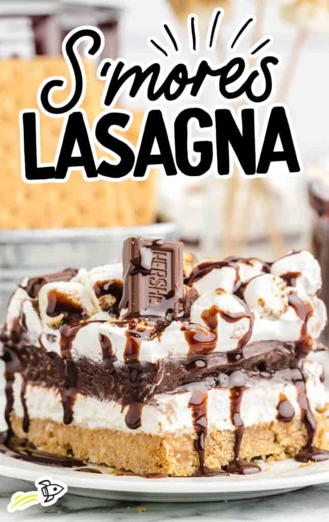 S'mores lasagna is on a plate with a chocolate bar.