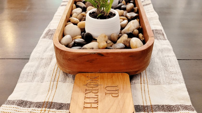 A wooden tray with a plant in it.