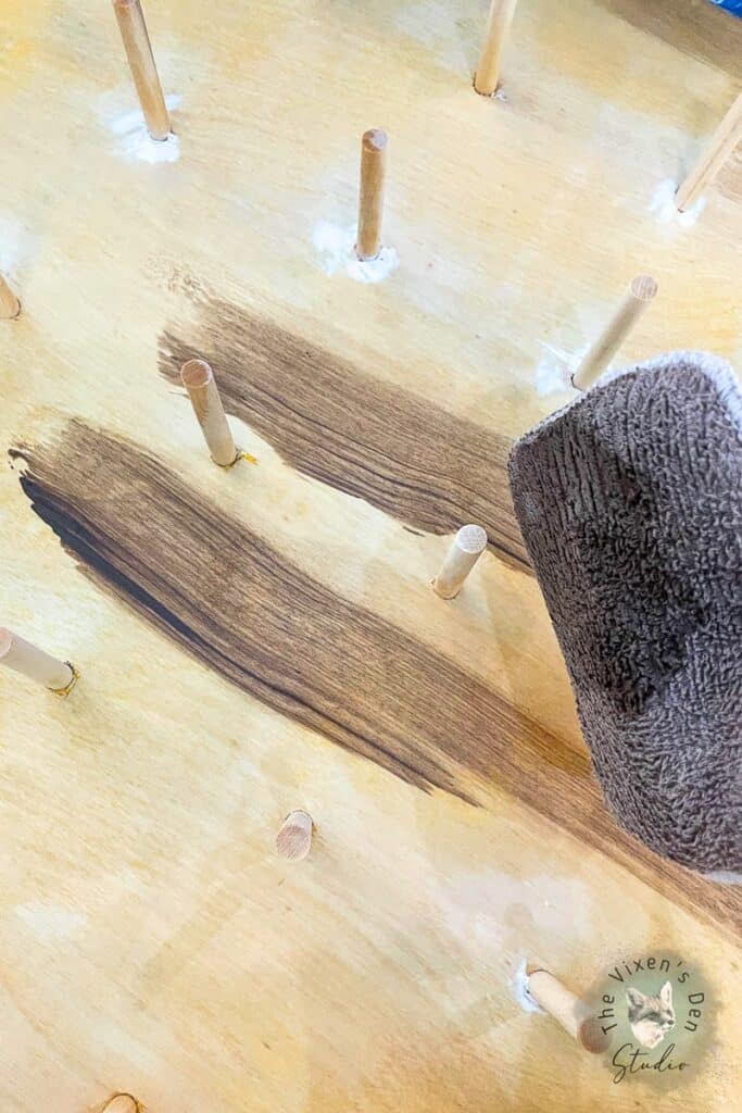 A piece of wood with a stain being applied to it.