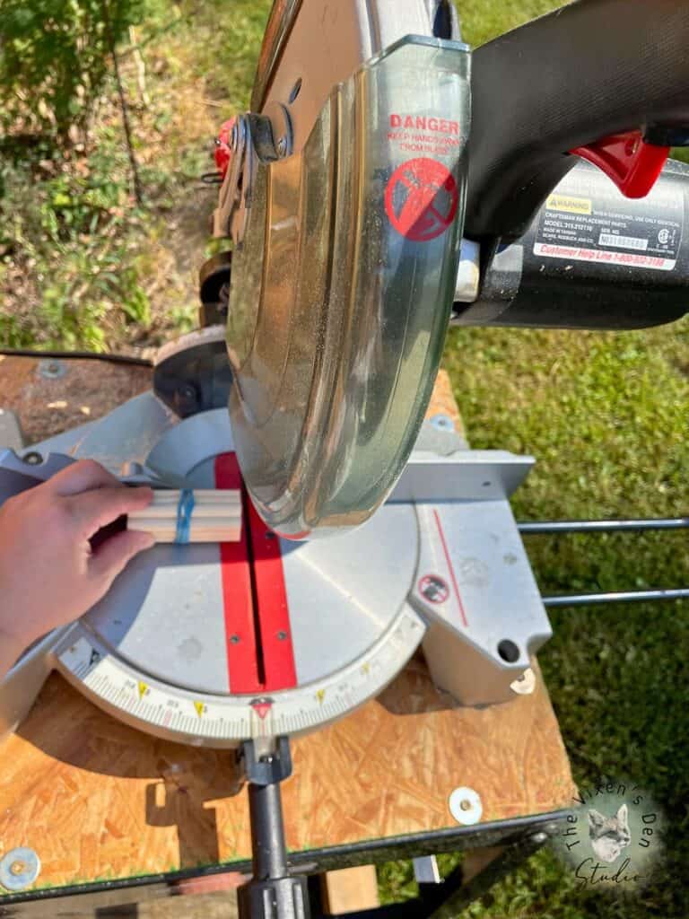 A person using a circular saw on a table.