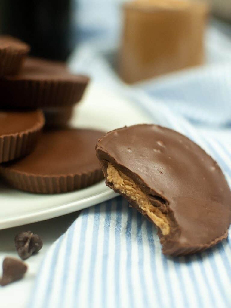 Peanut butter cups on a plate with chocolate chips.