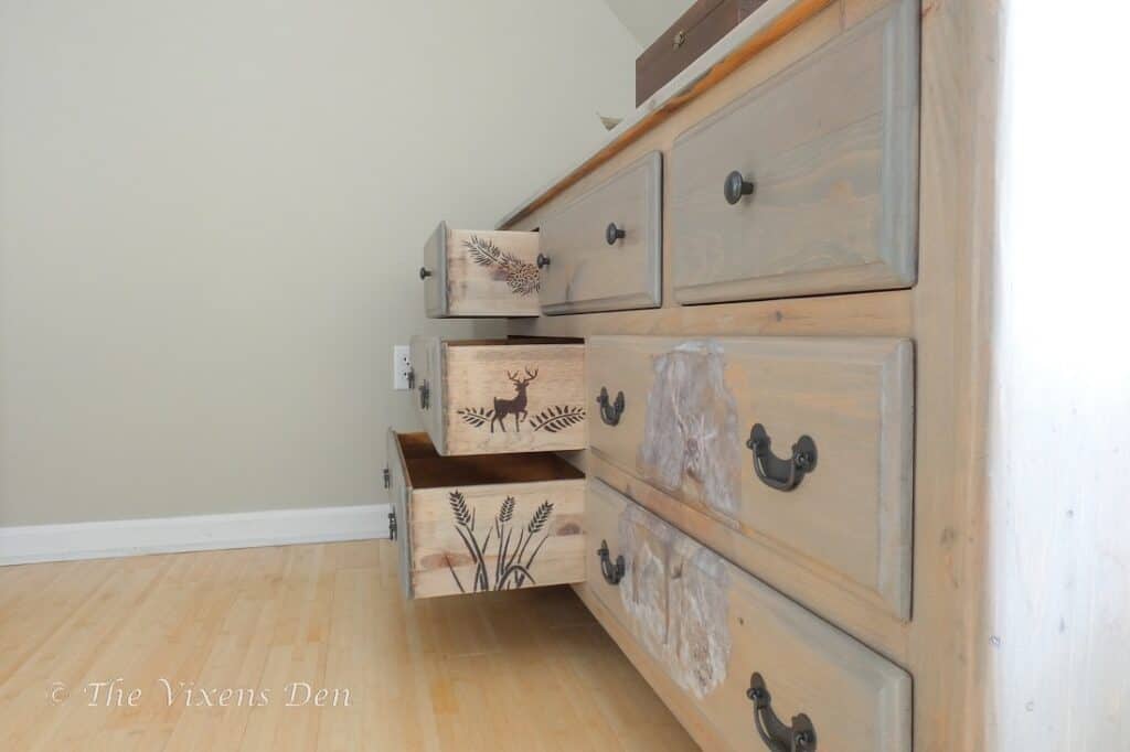 A dresser with drawers that are painted with animal designs.