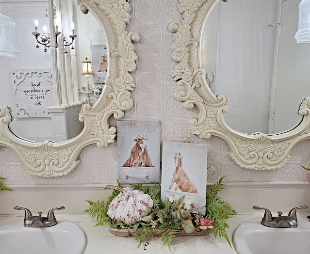 A bathroom with two mirrors and two sinks.