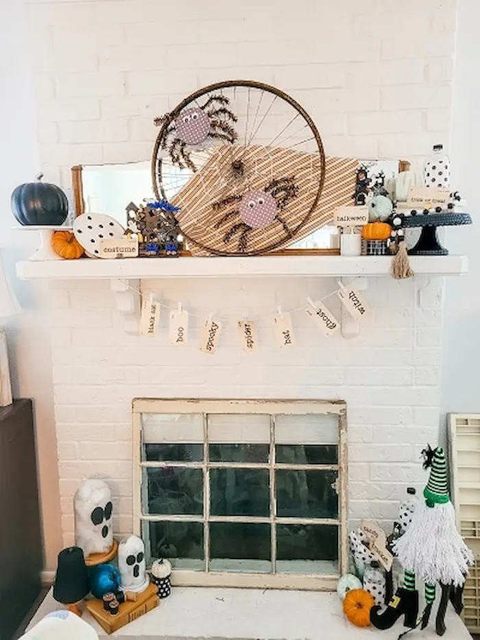 A fireplace mantel decorated for halloween.