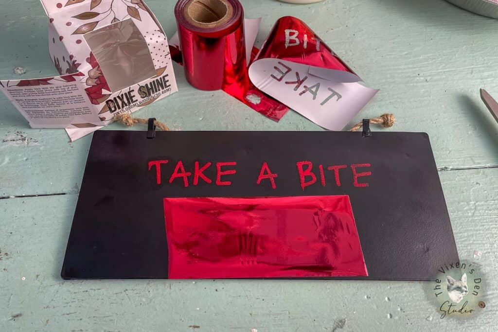 A sign that says take a bite on a table.