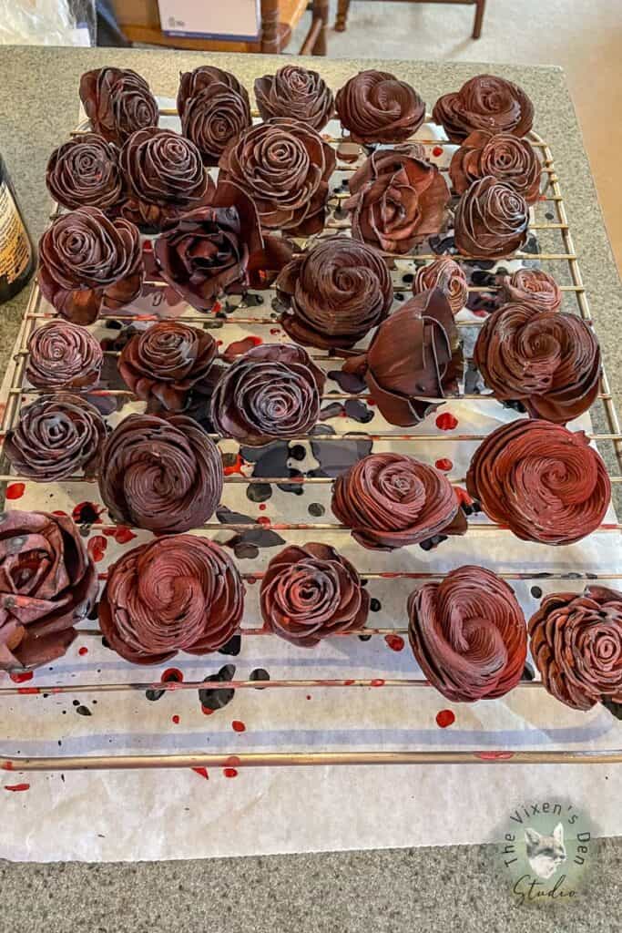 Chocolate colored roses on a cooling rack.