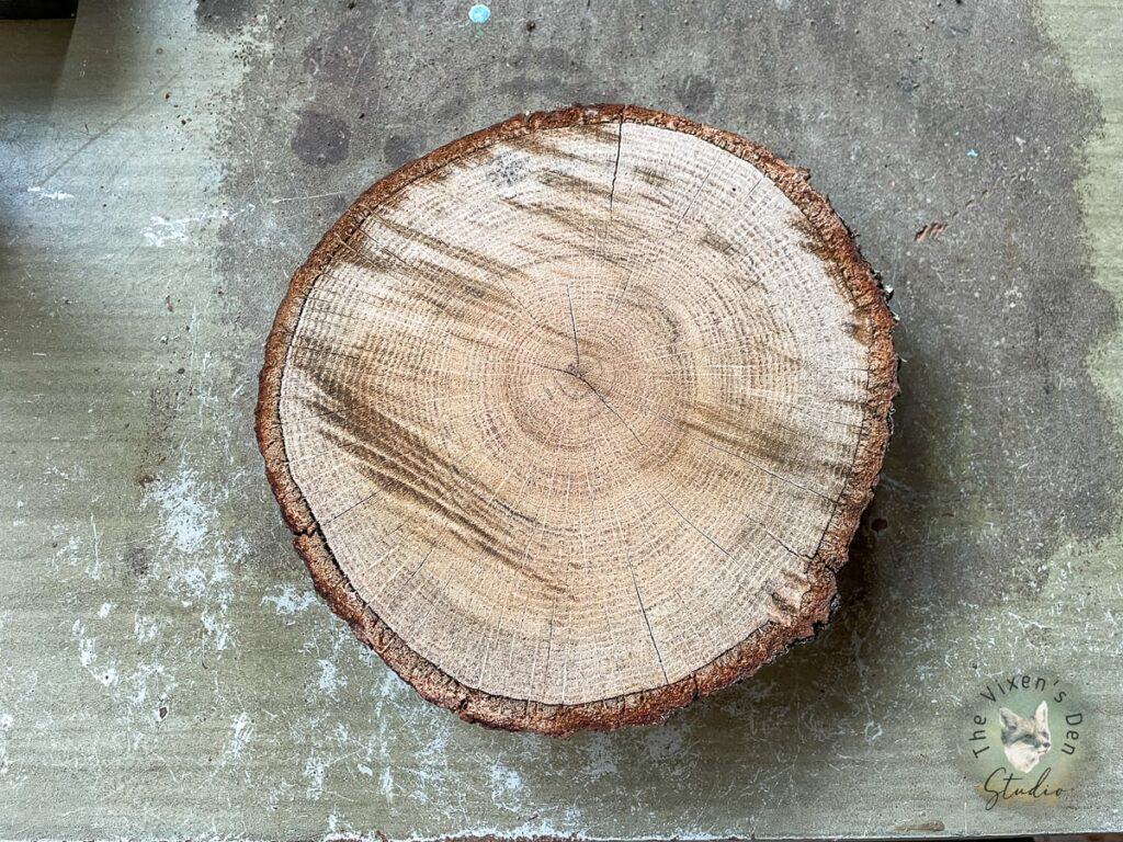 A slice of wood sitting on top of a table.