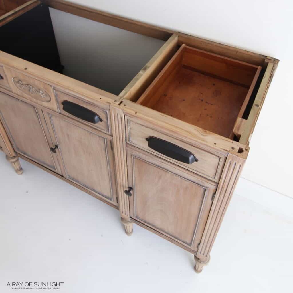 An old wooden sideboard with drawers open.