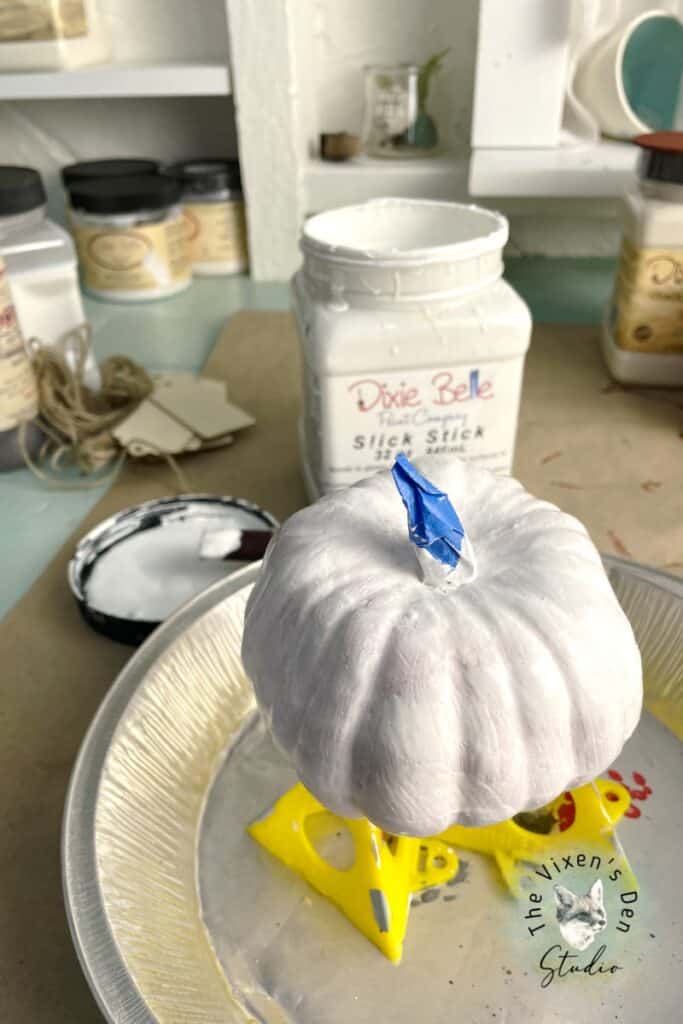 A white pumpkin sitting on top of a plate.