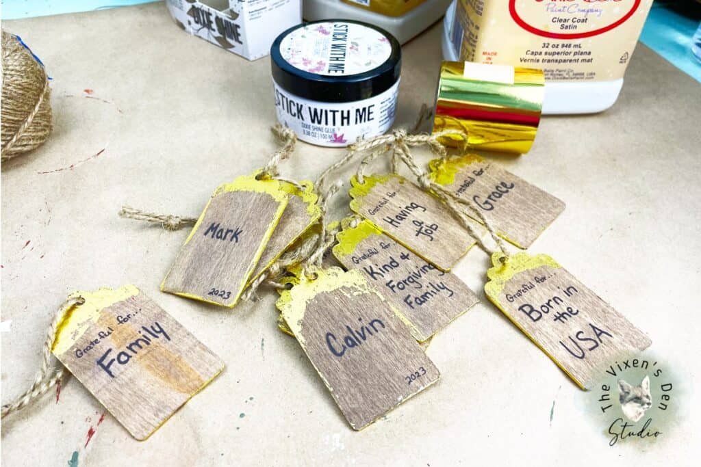A group of wooden tags with paint on them.
